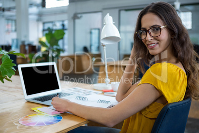 Female graphic designer working at desk