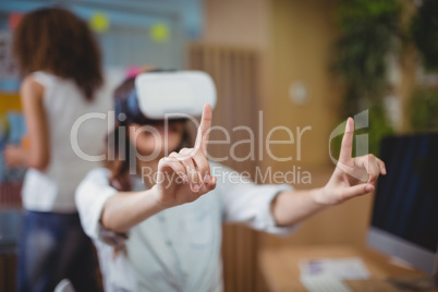 Female business executive using virtual reality headset