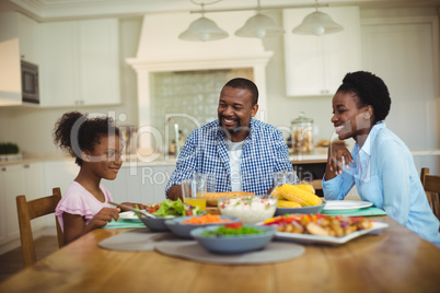 Family having meal on dinning table at home