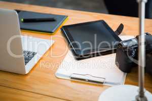 Laptop, digital tablet and digital camera on desk