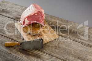 Beef ribs rack and knife on wooden tray against wooden background
