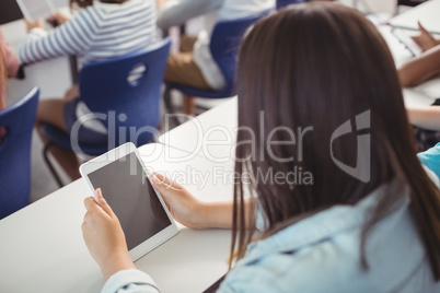 Student using digital tablet in classroom