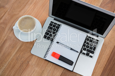 Cup of coffee with organizer and laptop