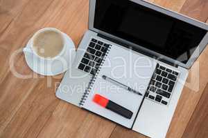 Cup of coffee with organizer and laptop