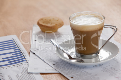 Coffee cup with saucer, spoon and documents