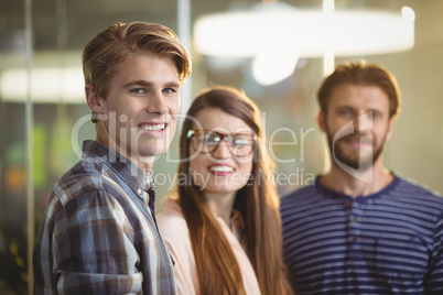 Happy business executives standing in office