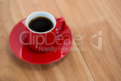 Black coffee served in red cup