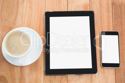 Cup of coffee with digital table and mobile phone