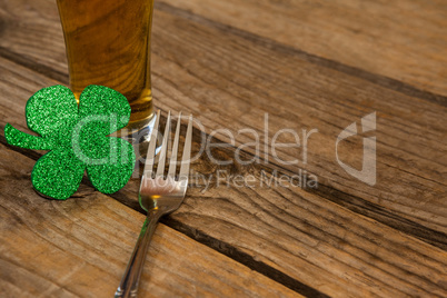 Glass of beer, fork and shamrock for St Patricks Day