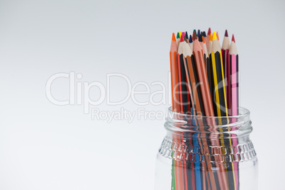 Colored pencils kept in a glass jar