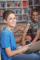 Portrait of schoolboys studying in library