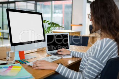 Female graphic designer working at desk