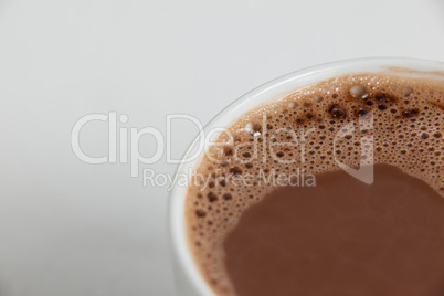 Close-up of white coffee cup with froth