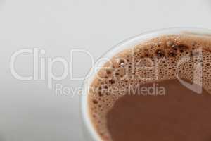 Close-up of white coffee cup with froth