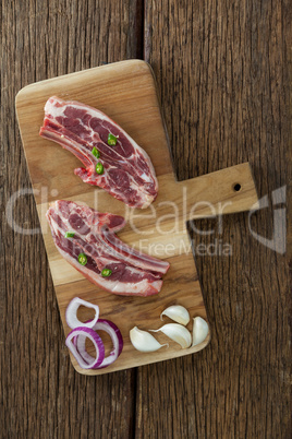 Blade chop, onions and garlic on wooden board