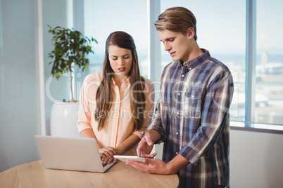 Business executives using digital tablet and laptop