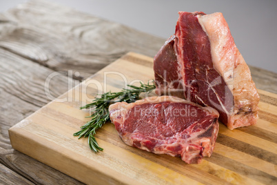 Sirloin chop on wooden tray against wooden background