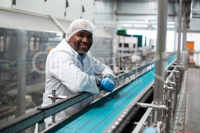 Factory engineer leaning on production line