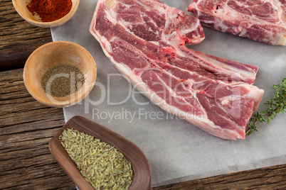 Sirloin steak and ingredients against wooden background