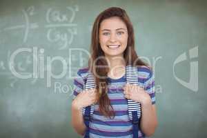 Portrait of schoolgirl standing in classroom