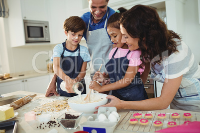 Happy family preparing cookies in kitchen