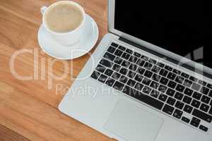 Cup of coffee and laptop