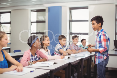 Schoolboy giving presentation in classroom