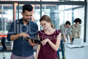 Business executives discussing over digital tablet in meeting