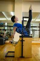 Determined woman exercising on wunda chair