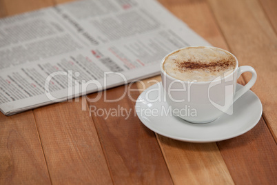 Close-up of black coffee and newspaper
