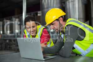 Factory workers using digital tablet