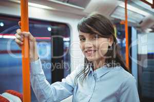 Executive smiling while traveling in train