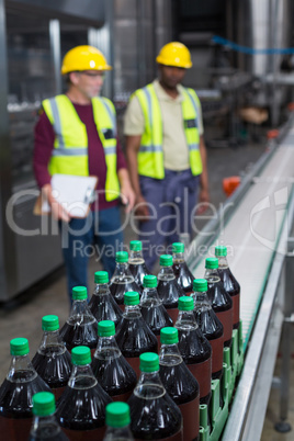 Crate of cold drink bottles moving on the production line