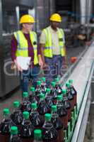 Crate of cold drink bottles moving on the production line