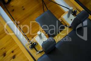 Close-up of reformer on wooden floor