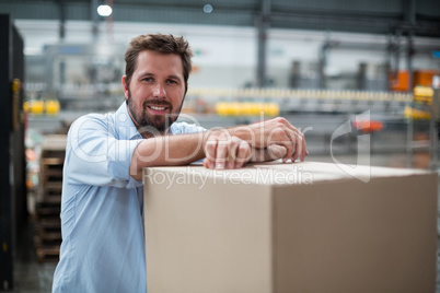 Smiling factory worker standing in factory