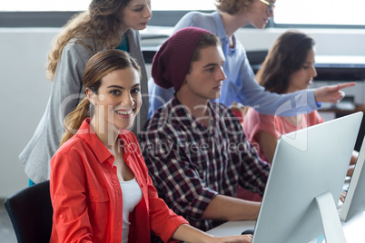 Portrait of smiling business executive working on computer in office