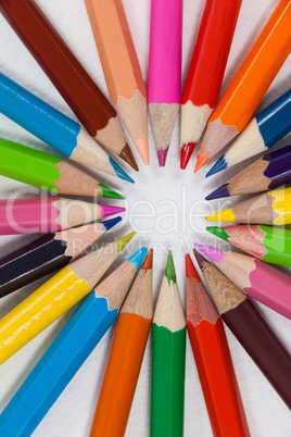 Close-up of colored pencils arranged in a circle