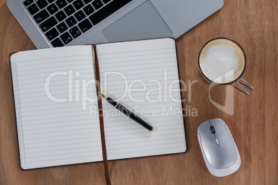 Cup of coffee with laptop, mouse, pen and organizer