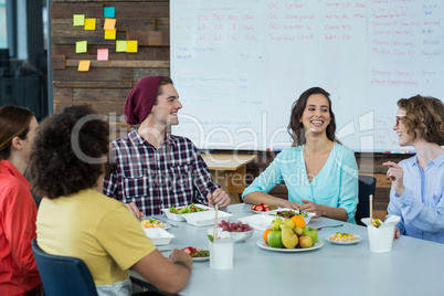 Smiling business executives having meal in office