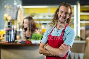 Smiling shop assistant standing in health grocery shop