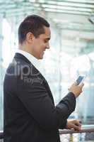 Businessman using mobile phone on platform