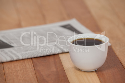 Close-up of black coffee and newspaper
