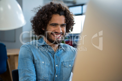 Smiling graphic designer working on computer