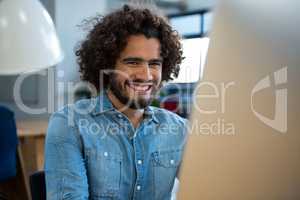 Smiling graphic designer working on computer