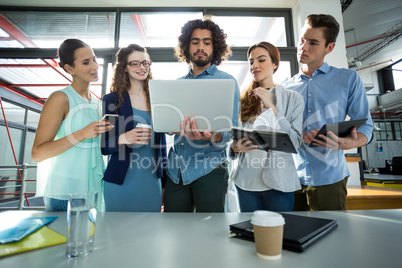 Business team discussing over laptop in meeting