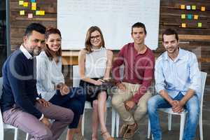 Portrait of businesspeople sitting on chair