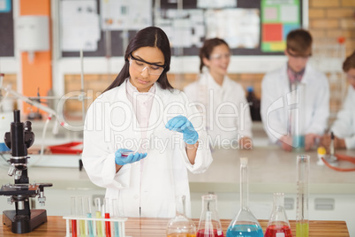 School girl experimenting with chemical in laboratory at school