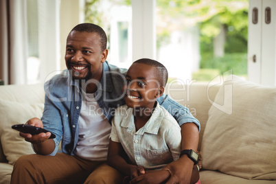 Son and father watching television