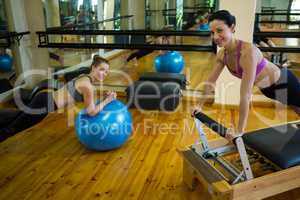 Happy women exercising in gym